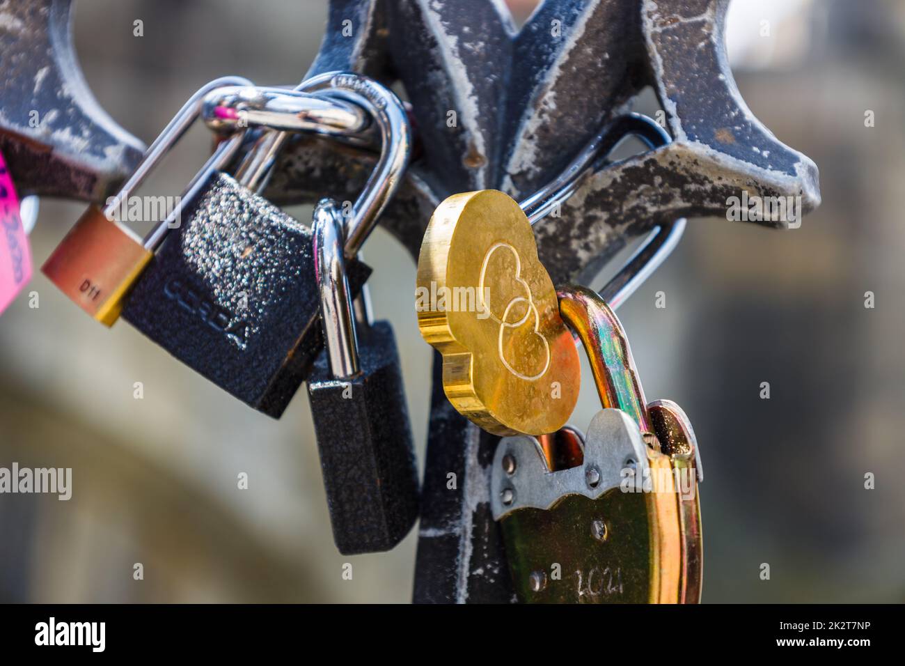 Closeup view of heart-shaped love padlock hanging on a bridge fence ...