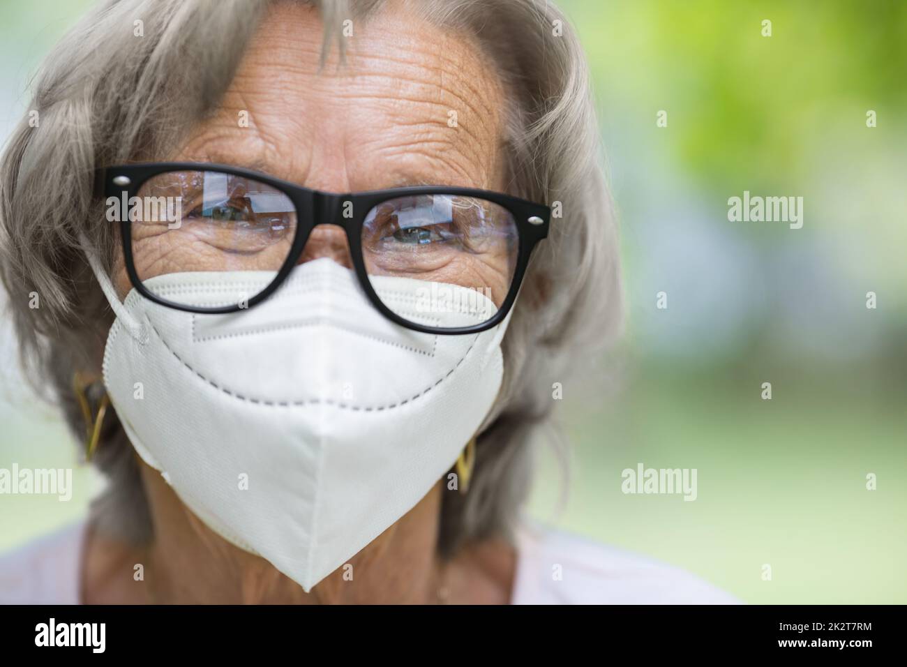 Elderly woman wearing a mask hi-res stock photography and images - Alamy