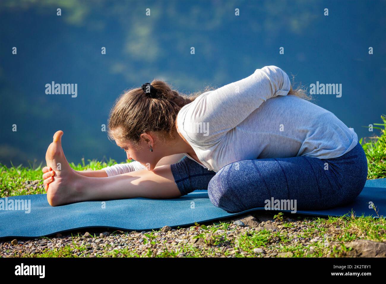 Woman doing yoga asana outdoors Stock Photo