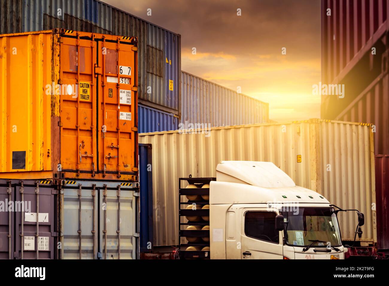 Logistic container with trailer truck. Cargo and shipping business. Container for truck transport. Container ship for import and export logistics. Logistic industry. Supply chain. Container freight. Stock Photo