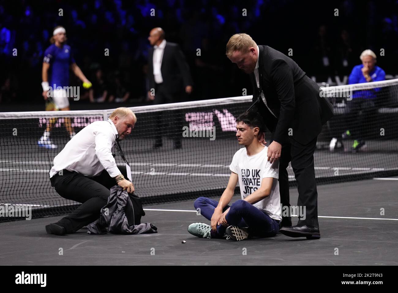 Steward remove a protester after setting fire to the court on day one of the Laver Cup at the O2 Arena, London. Picture date: Friday September 23, 2022. Stock Photo