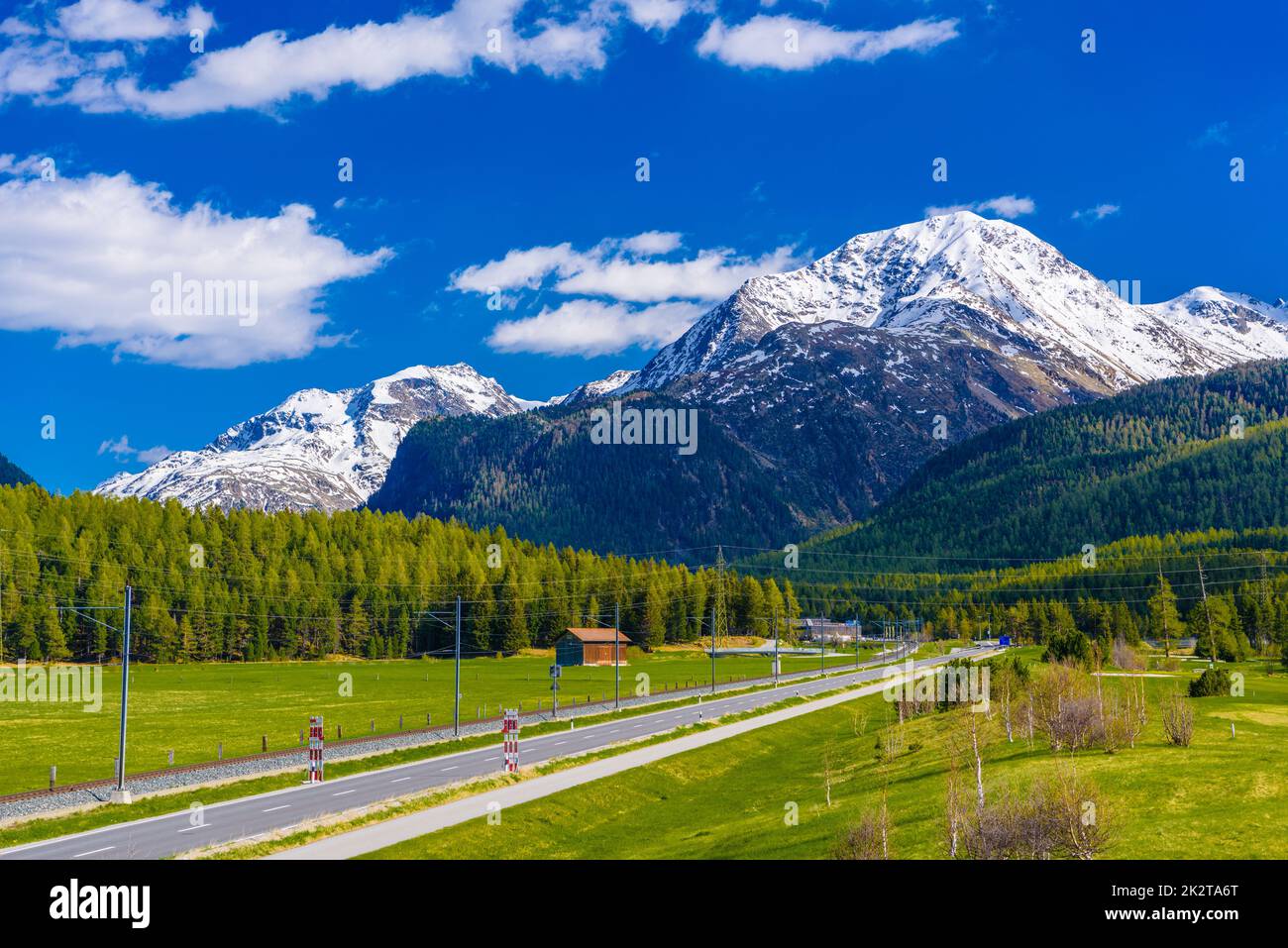 Road with Alps mountains, Samedan, Maloja, Graubuenden, Switzerl Stock Photo