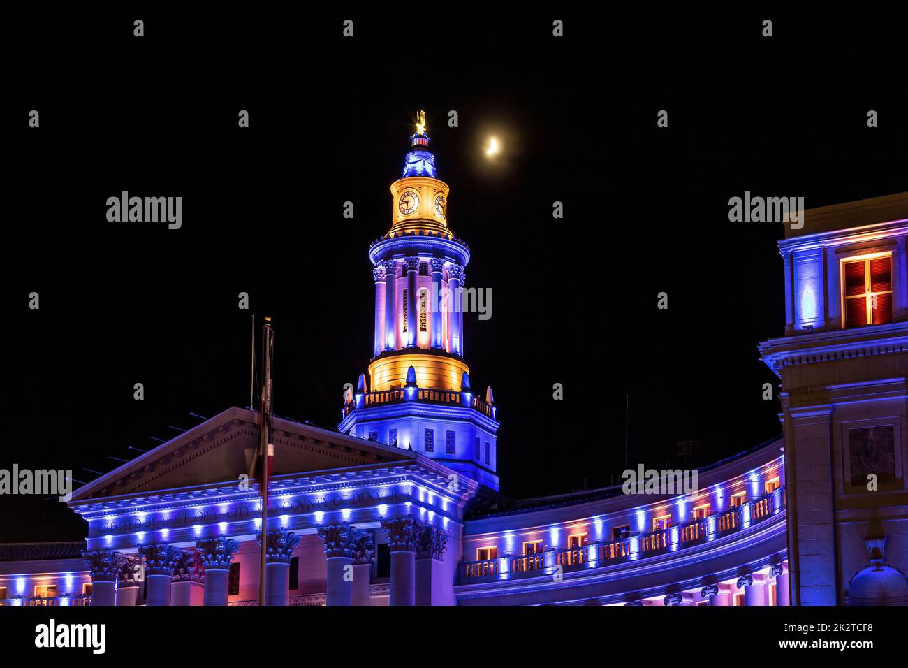 Moon over Denver City & County Building illuminated with colors representing United States Navy, Independence Eve Celebration, Denver, Colorado USA Stock Photo