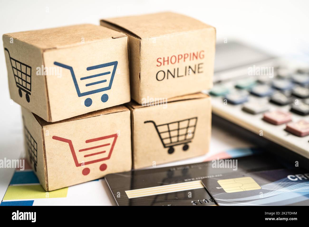 Shopping online box with credit card and calculator on graph. Finance commerce import export business concept. Stock Photo