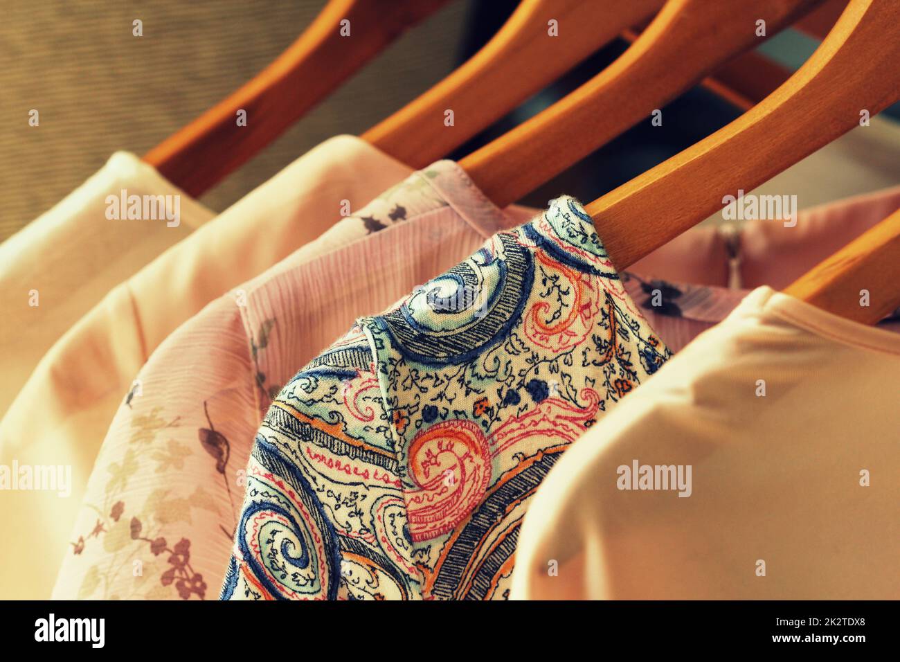 collection of women's clothes hanging on rack Stock Photo