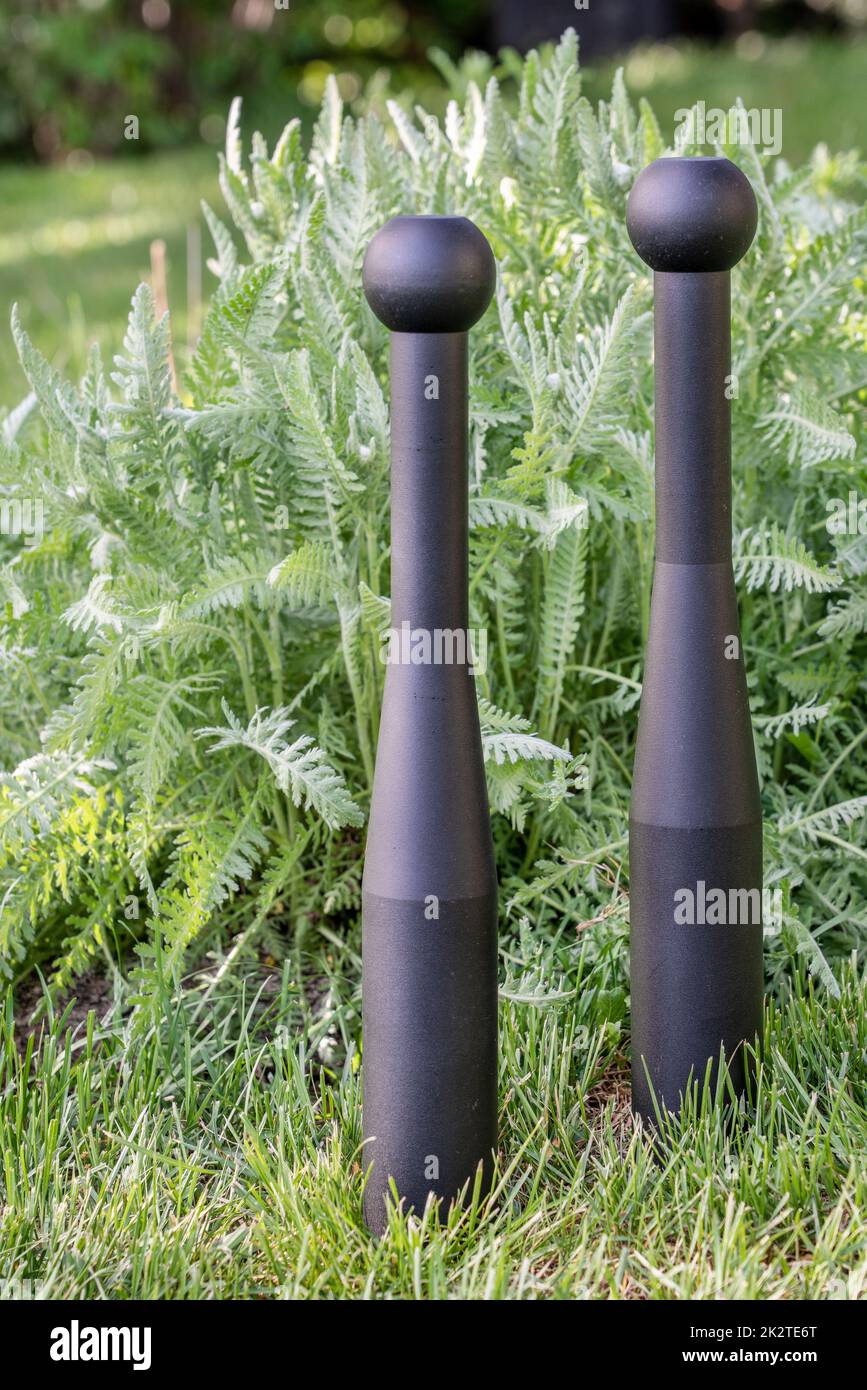 pair of heavy steel clubs in backyard Stock Photo Alamy