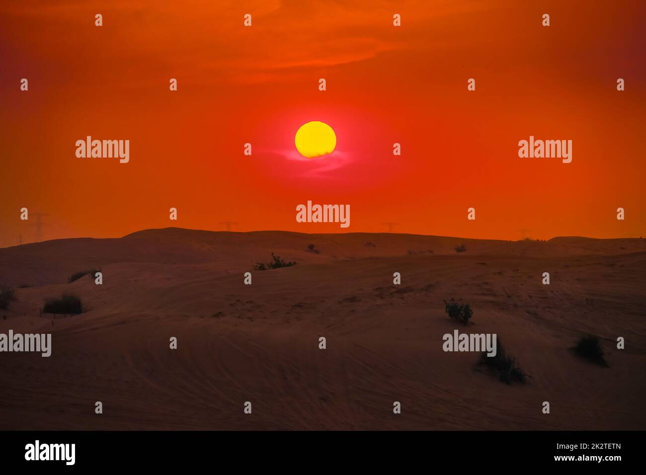 Sun sinking in the Arabian desert. Shooting Location: Dubai Stock Photo