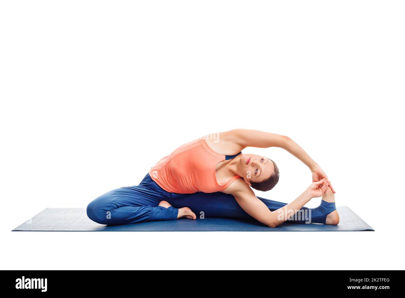 Sporty fit yogini woman practices yoga asana parivrtta janu sirs Stock Photo
