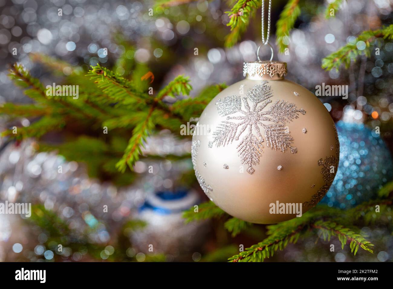 Decoration bauble on decorated Christmas tree background Stock Photo