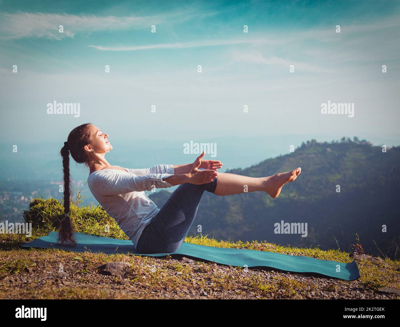 Woman doing Ashtanga Vinyasa Yoga asana Navasana - boat pose Stock ...