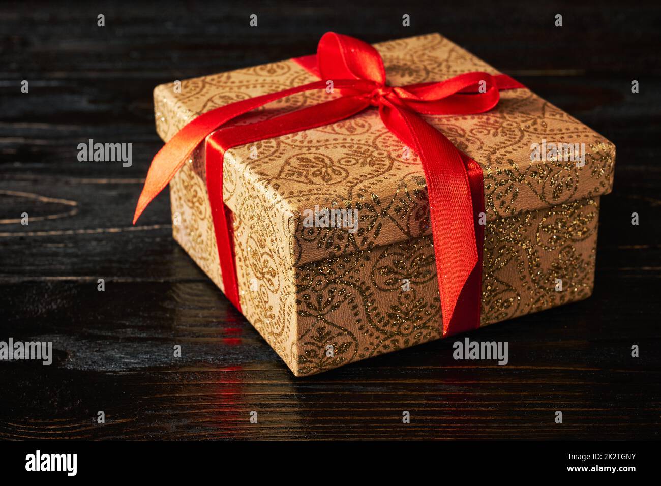 Gift box with red ribbon Stock Photo - Alamy