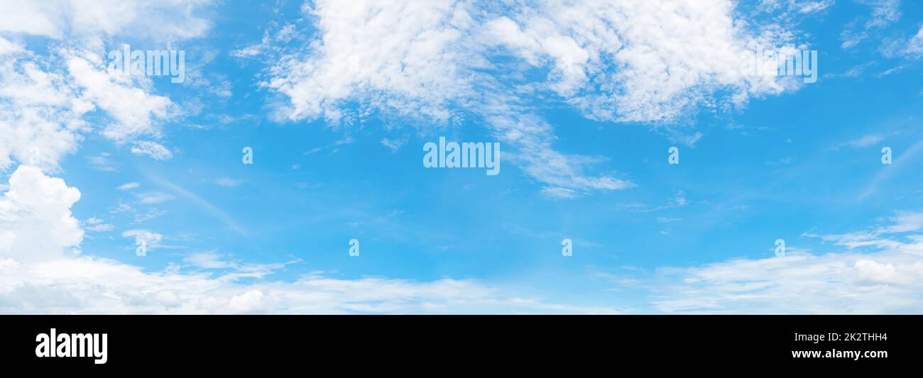 Beautiful blue sky and white cumulus clouds background. Cloudscape background. Blue sky and fluffy white clouds on sunny day. Nature weather. Panorama view of blue sky for happy day background. Stock Photo