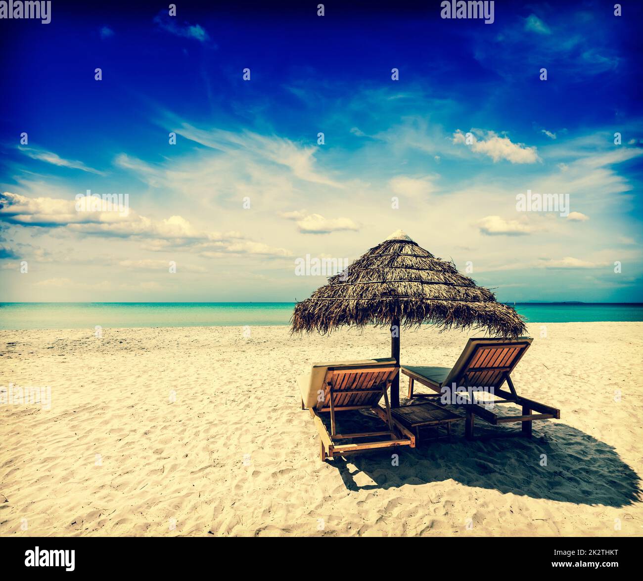 Two lounge chairs under tent on beach Stock Photo Alamy