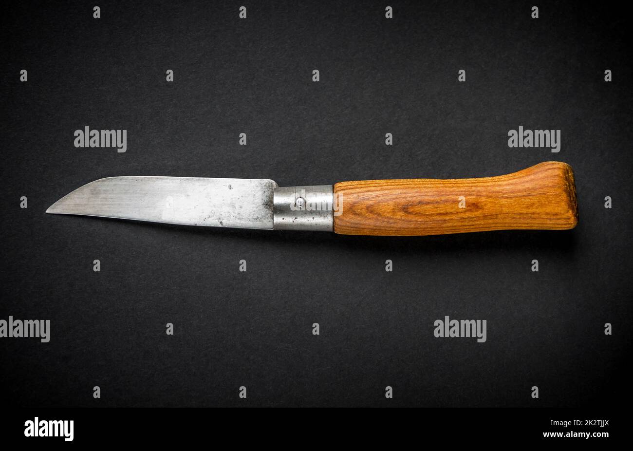 Traditional wooden pocket knife on black background Stock Photo
