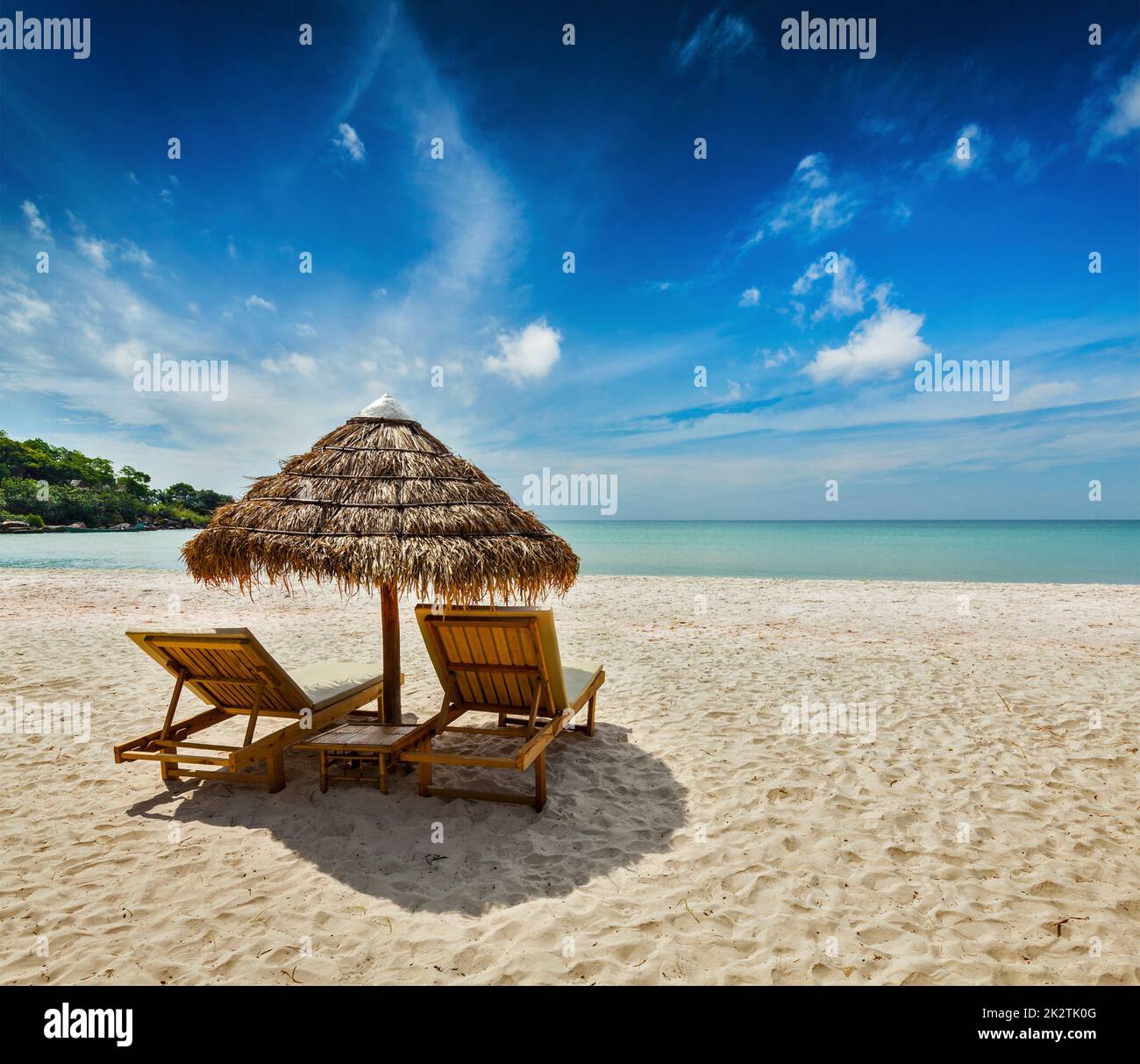 Two beach lounge chairs under tent Stock Photo