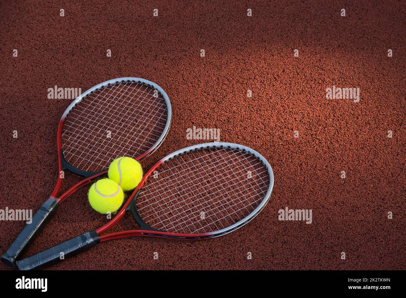 Tennis ball, racquet on hard court surface Stock Photo