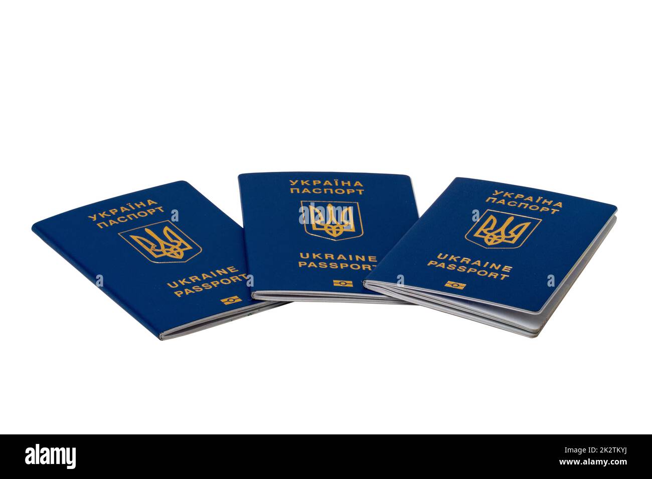 Three passports of Ukrainian citizens or migrants for visa-free travel to the European Union isolated on white background. Clipping path. Refugees in European countries. Stock Photo