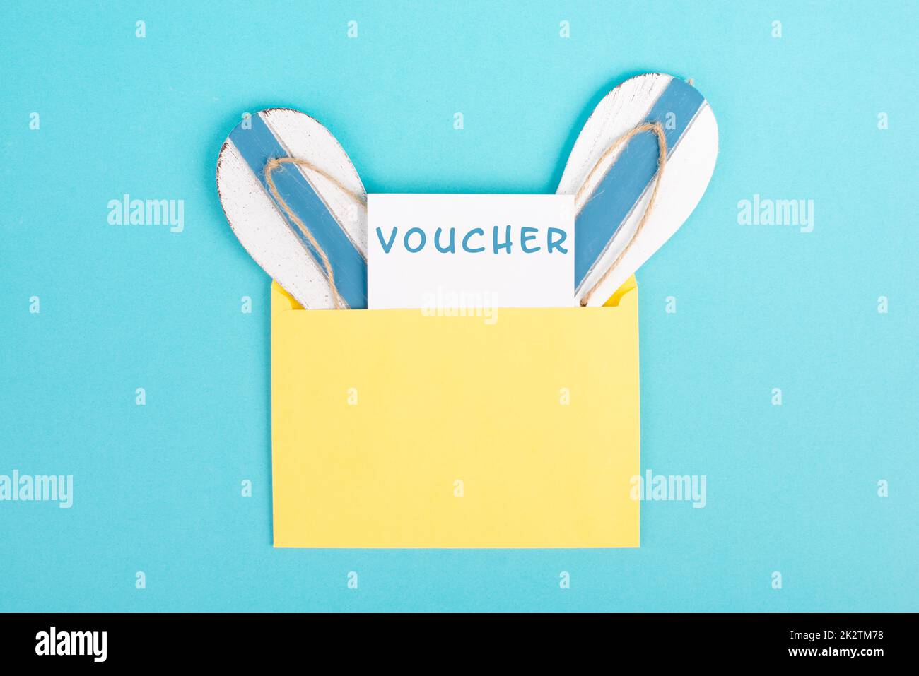 Blue colored summer and vacation background, voucher, flip flops in an envelope, copy space for text, holiday and tourism concept Stock Photo