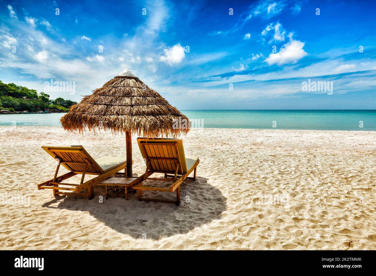 Two lounge chairs under tent on beach Stock Photo
