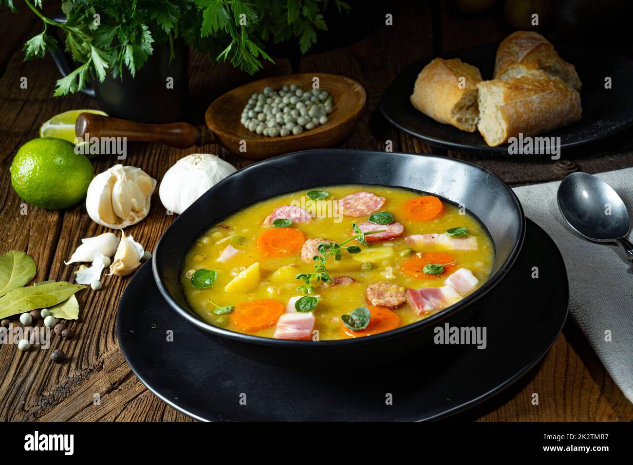 Hearty rustic pea soup with bacon and sausage Stock Photo