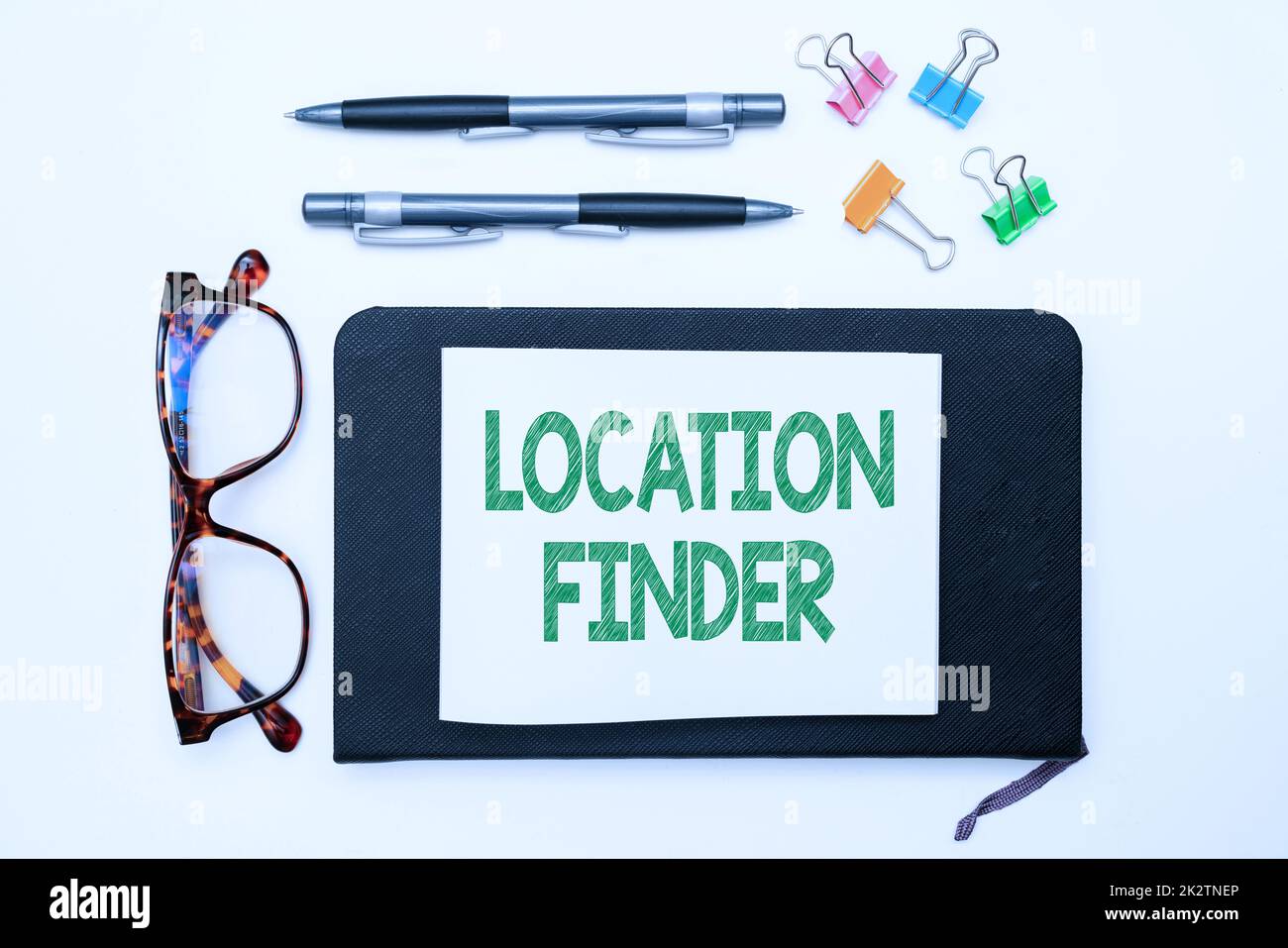 Text sign showing Location Finder. Conceptual photo A service featured to find the address of a selected place Office Supplies Over Desk With Keyboard And Glasses And Coffee Cup For Working Stock Photo