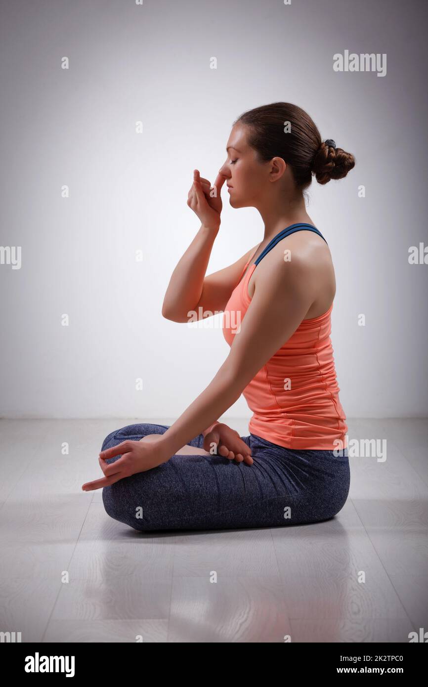 Sporty fit yogini woman practices yoga pranayama breath control Stock Photo