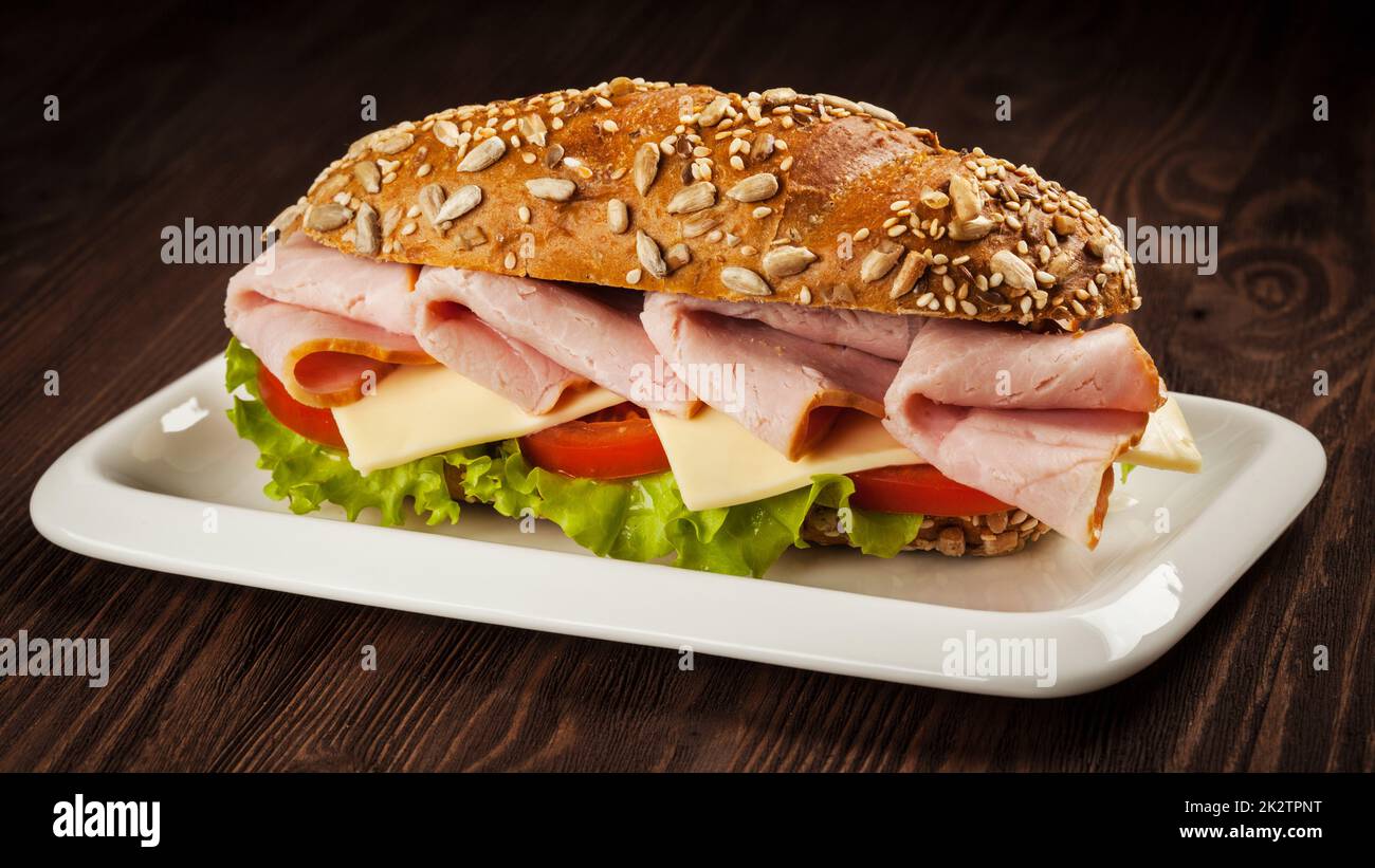 Ham sandwich on wooden background Stock Photo
