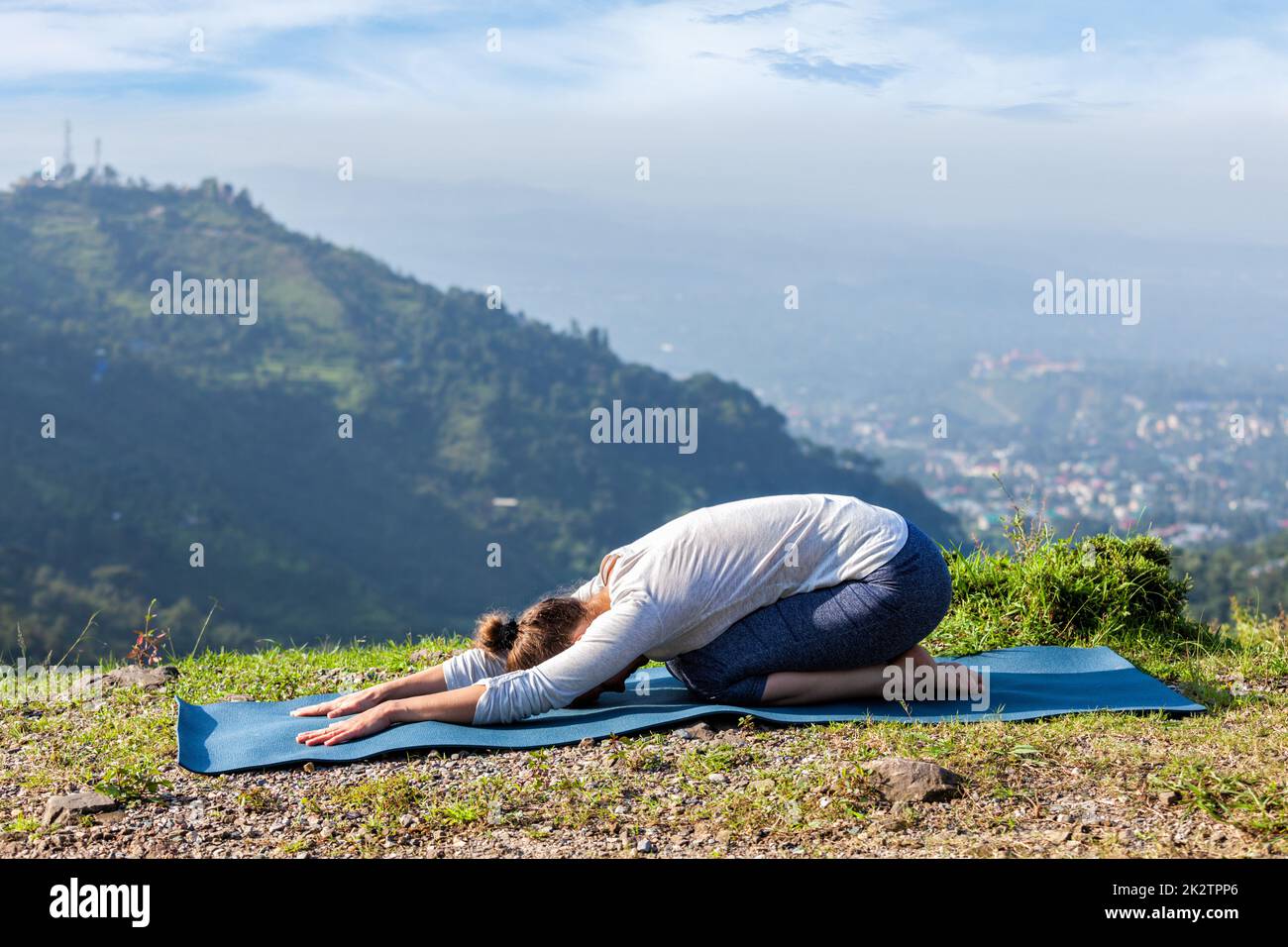 Sporty fit woman practices yoga asana Balasana Stock Photo