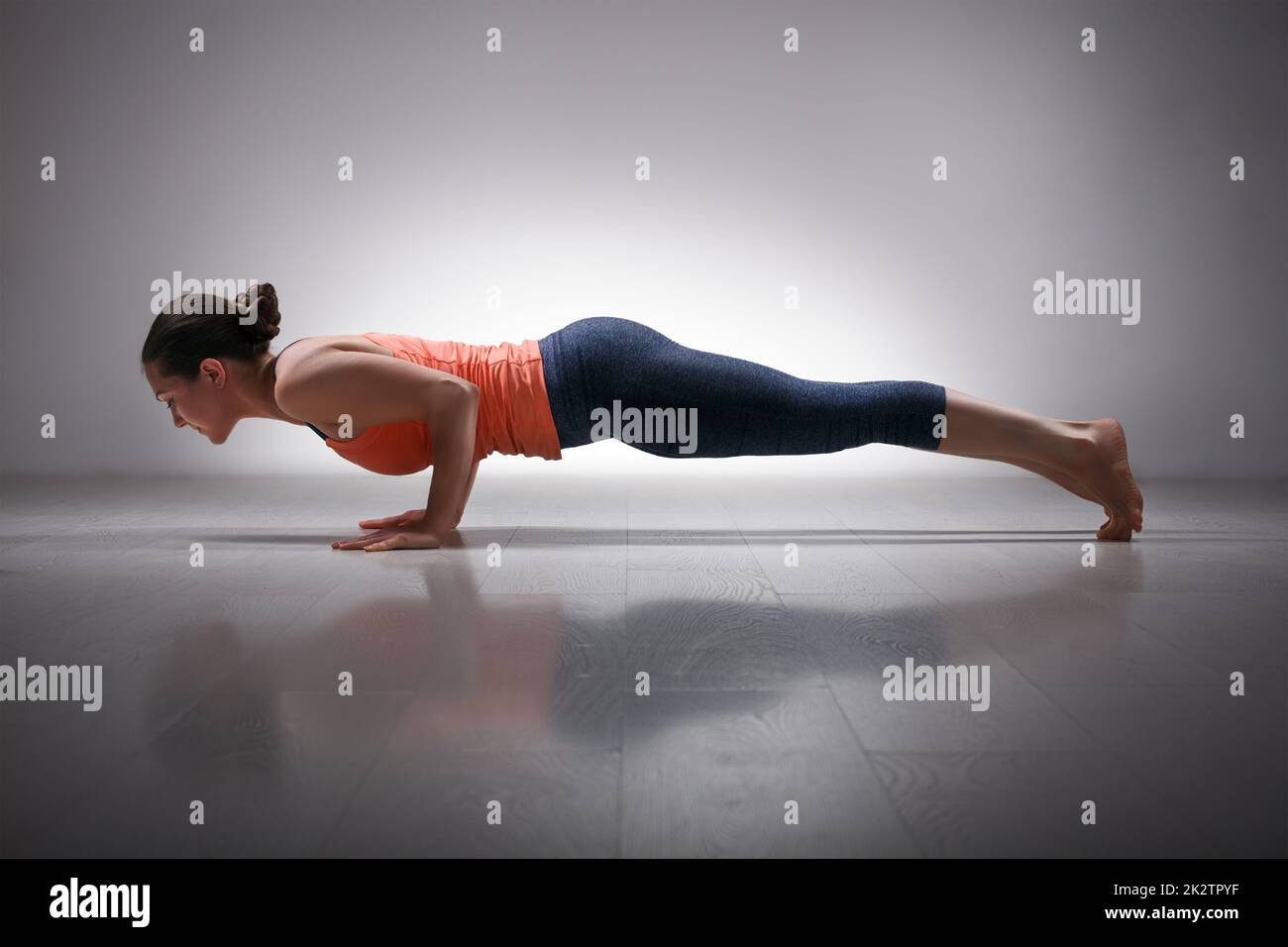 Premium Photo  Fit woman practicing chaturanga pose using online yoga  training program in the tablet at home