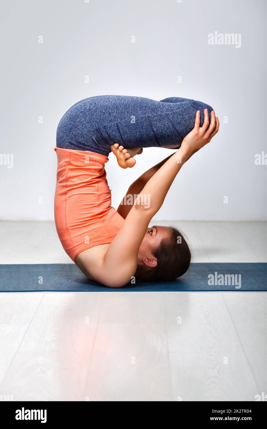 Woman practices inverted yoga asana Stock Photo