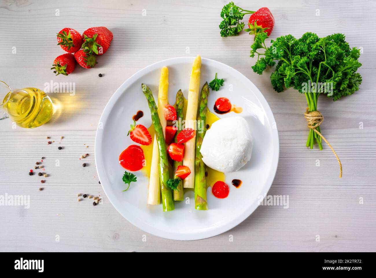 Burrata cheese with asparagus and strawberries Stock Photo