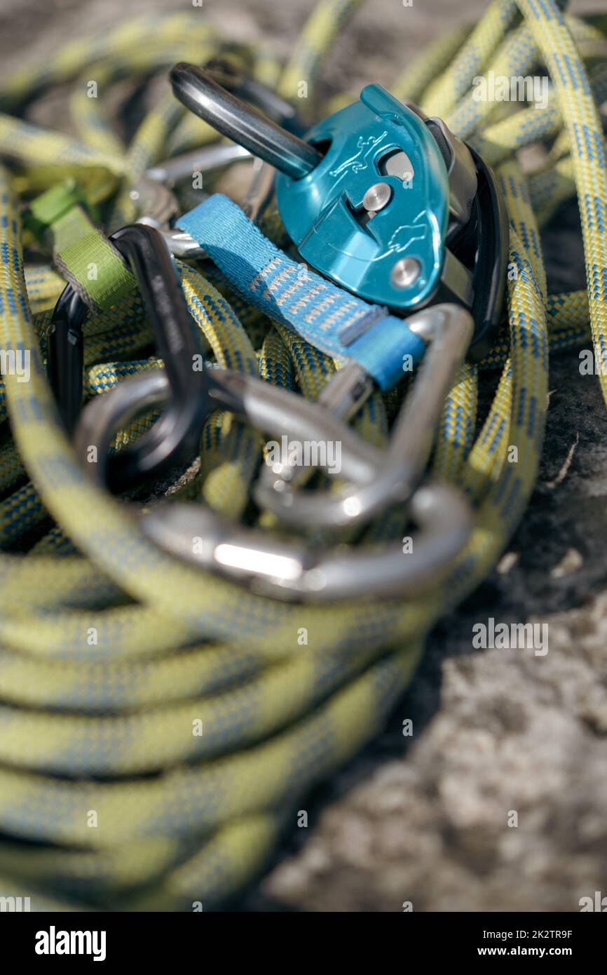 Rock climbing assisted belaying device and a green rope Stock Photo Alamy