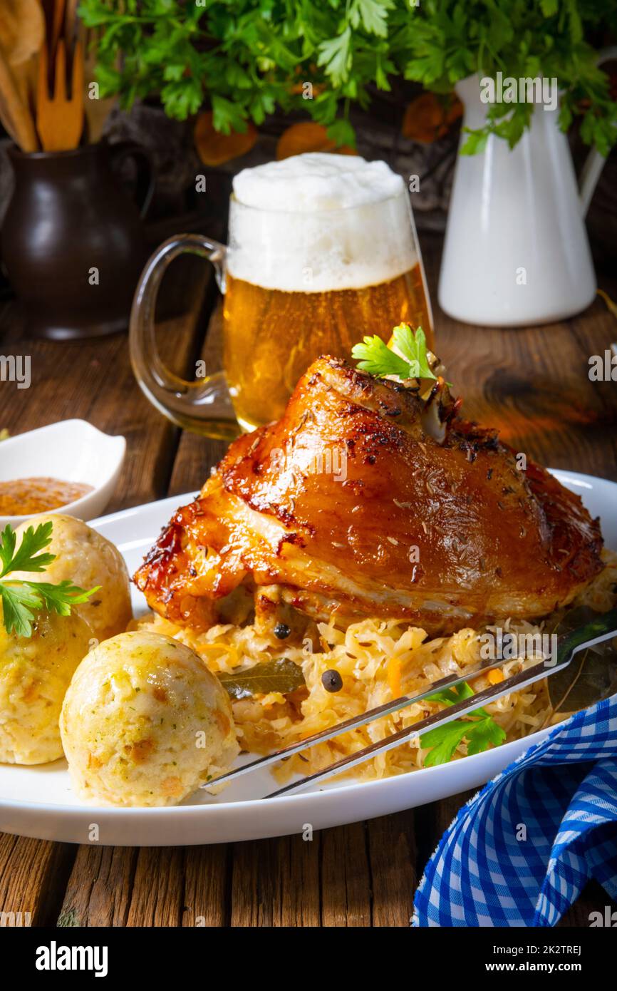 pork knuckle with sauerkraut and sweet mustard Stock Photo