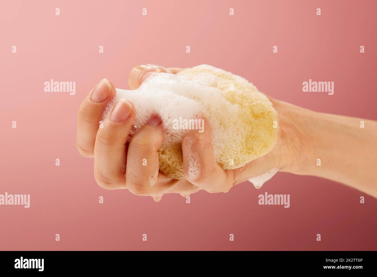 Squeeze out a yellow sponge Stock Photo