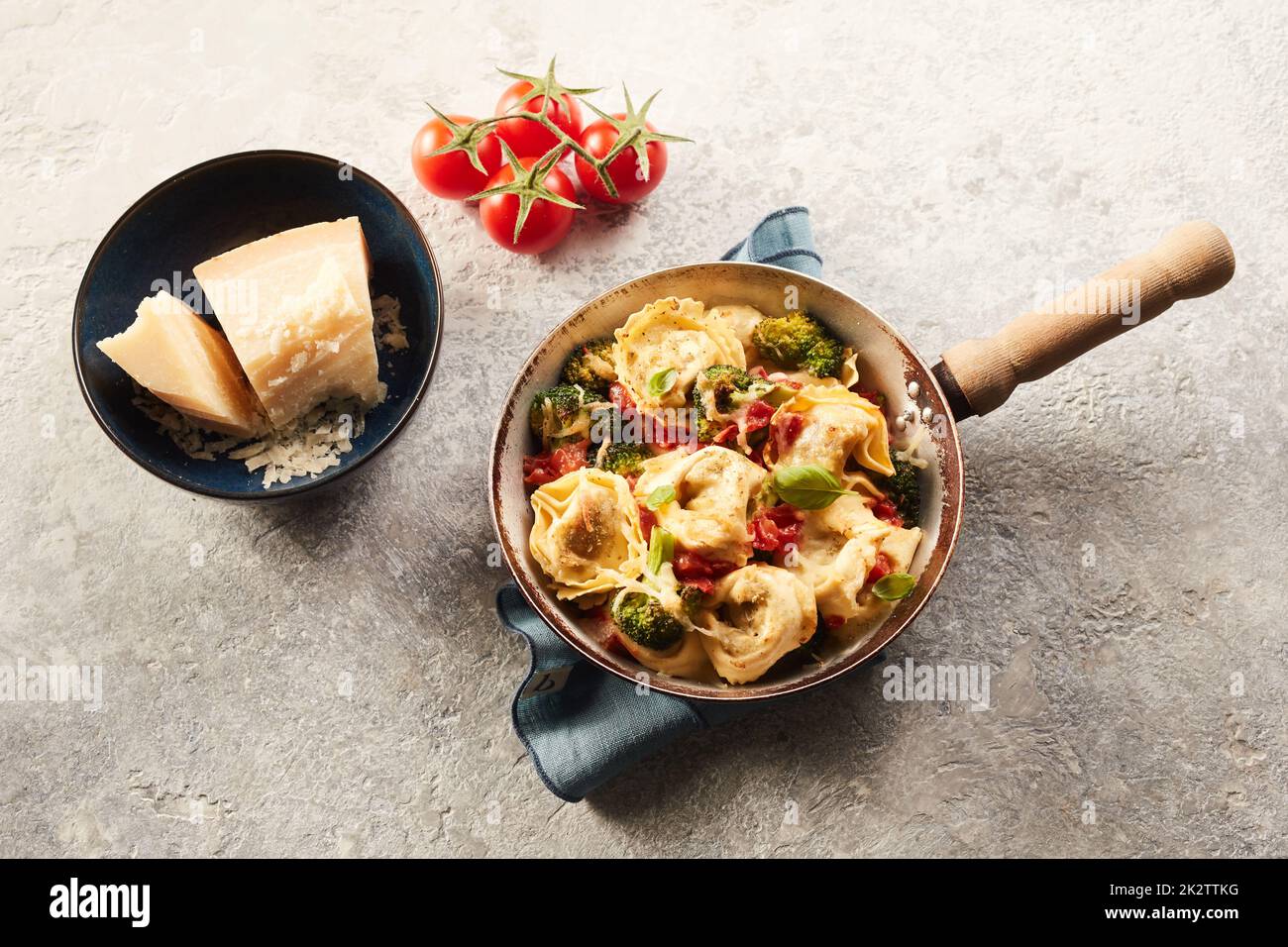 Delicious tortelloni pasta with tomatoes broccoli and cheese Stock