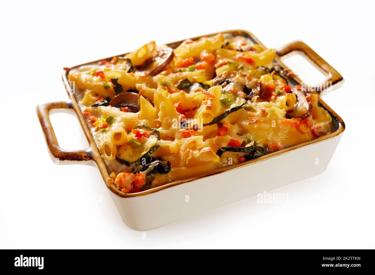 Delicious baked penne served on white table Stock Photo