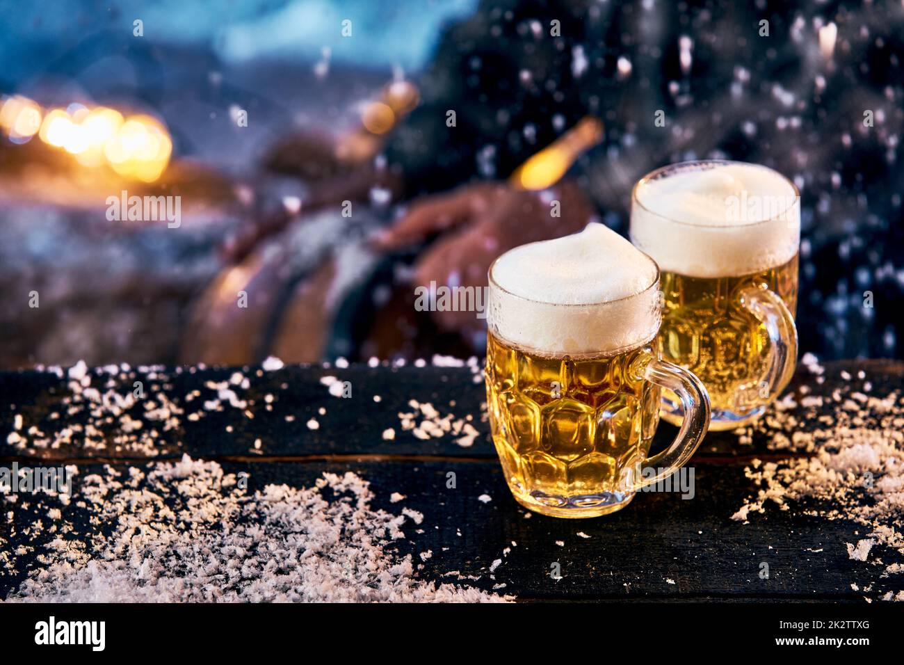 Glasses of beer on table in winter Stock Photo