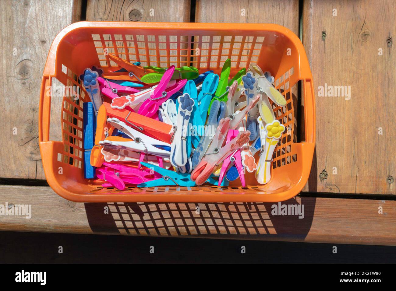 Clothespins multi-colored in a basket Stock Photo