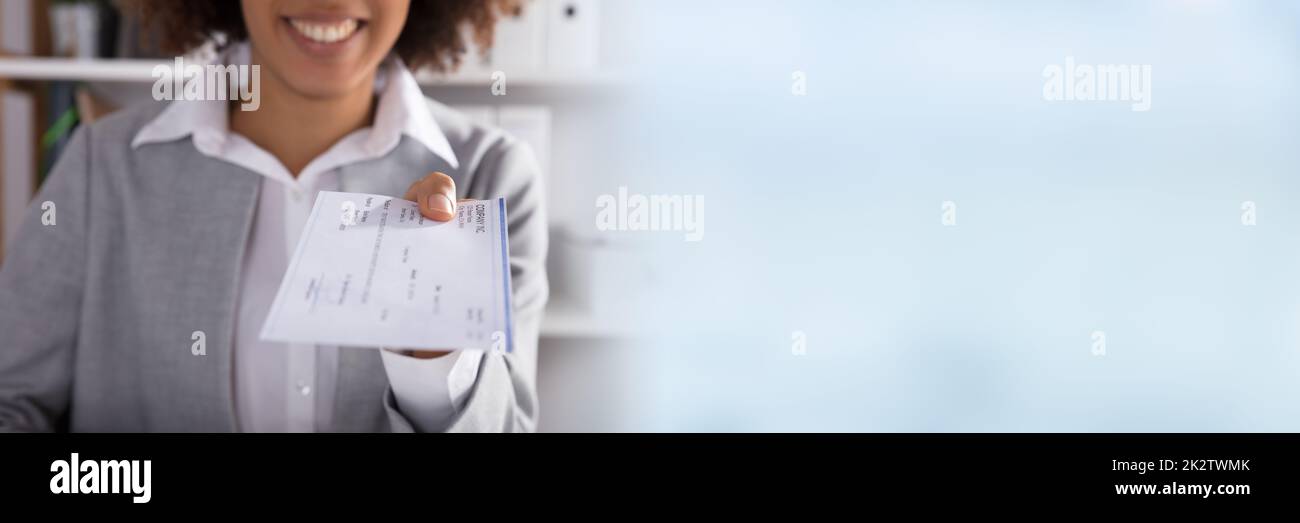 Businessperson Giving Cheque In Office Stock Photo