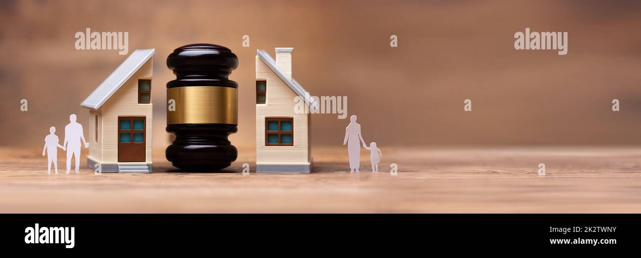 Gavel Between Split Family Figures And House Model Stock Photo