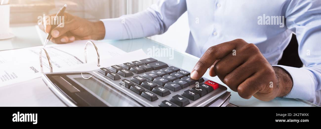 Businessman Calculating Invoice Stock Photo