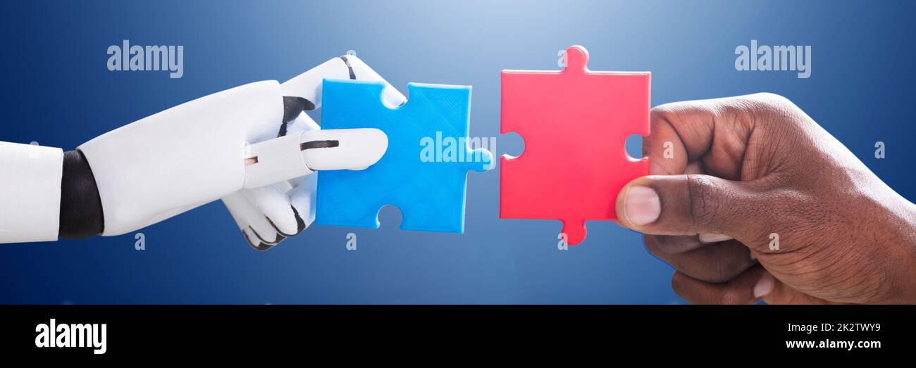 Robot And Human Hand Joining Jigsaw Stock Photo - Alamy