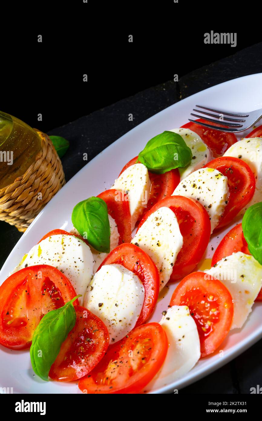 Tomato with mozzarella and basil Stock Photo