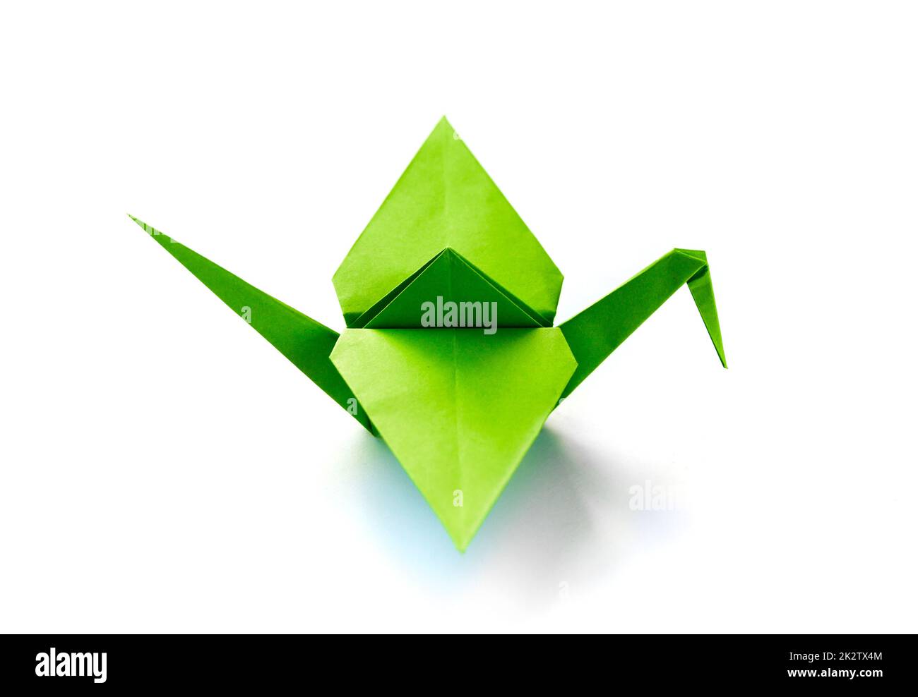 Green paper crane origami isolated on a white background Stock Photo