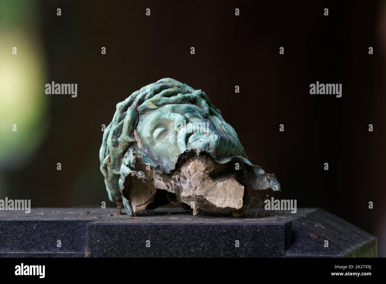 broken head of a crucifix on a tombstone Stock Photo