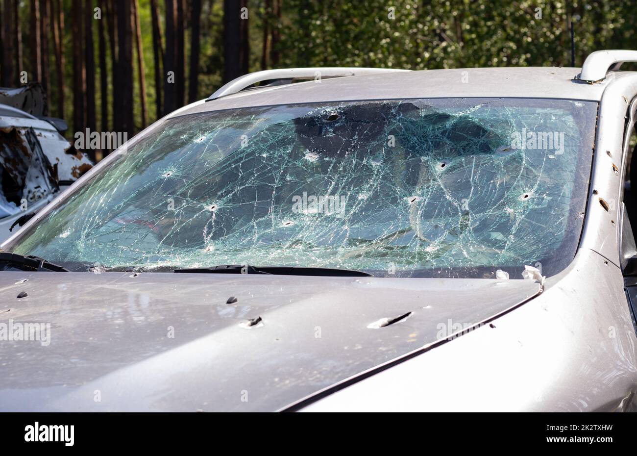 Holes on the windshield of the car, it was shot from a firearm. Bullet