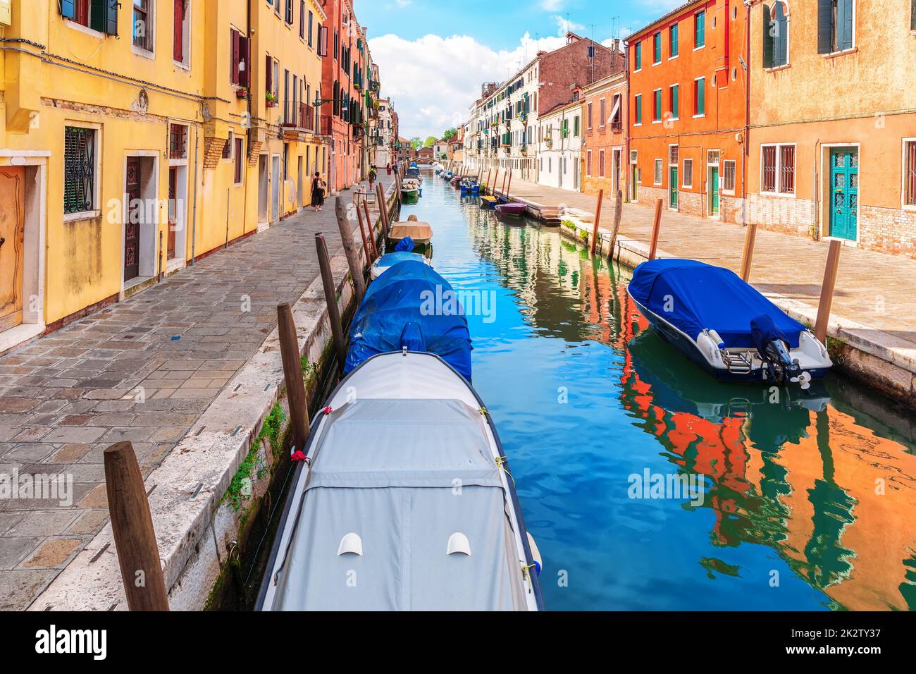 Boats moored near an italian street in the Grand Canal of Venice Stock Photo