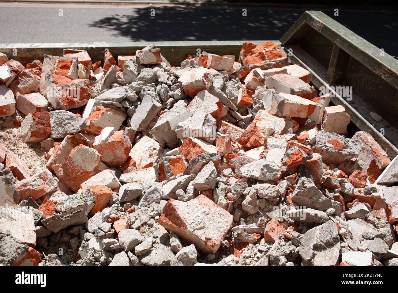 The building rubble in a dumpster. Mixed construction waste, red brick