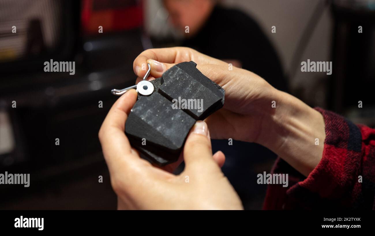 Holding new car brake pads, auto repair concept Stock Photo - Alamy