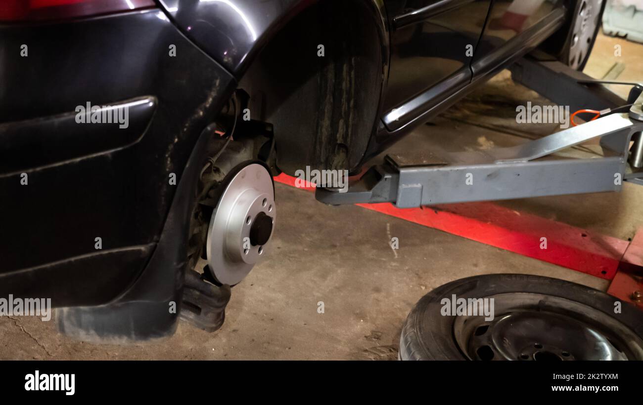 Replacing a new car brake disc Stock Photo